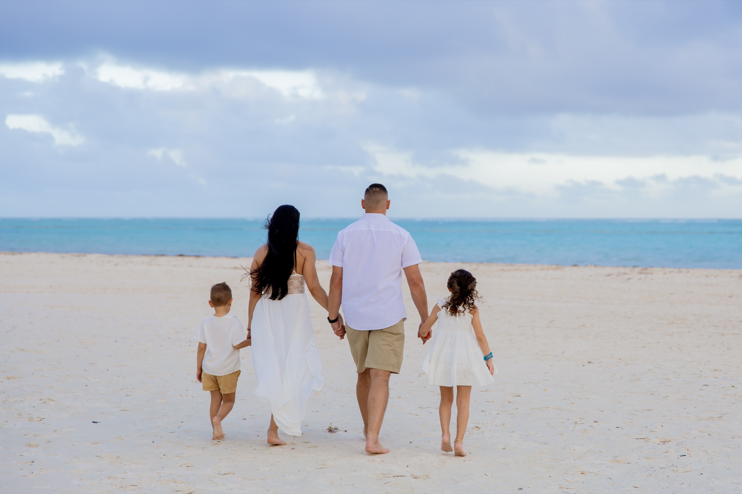 Family walking the beach together