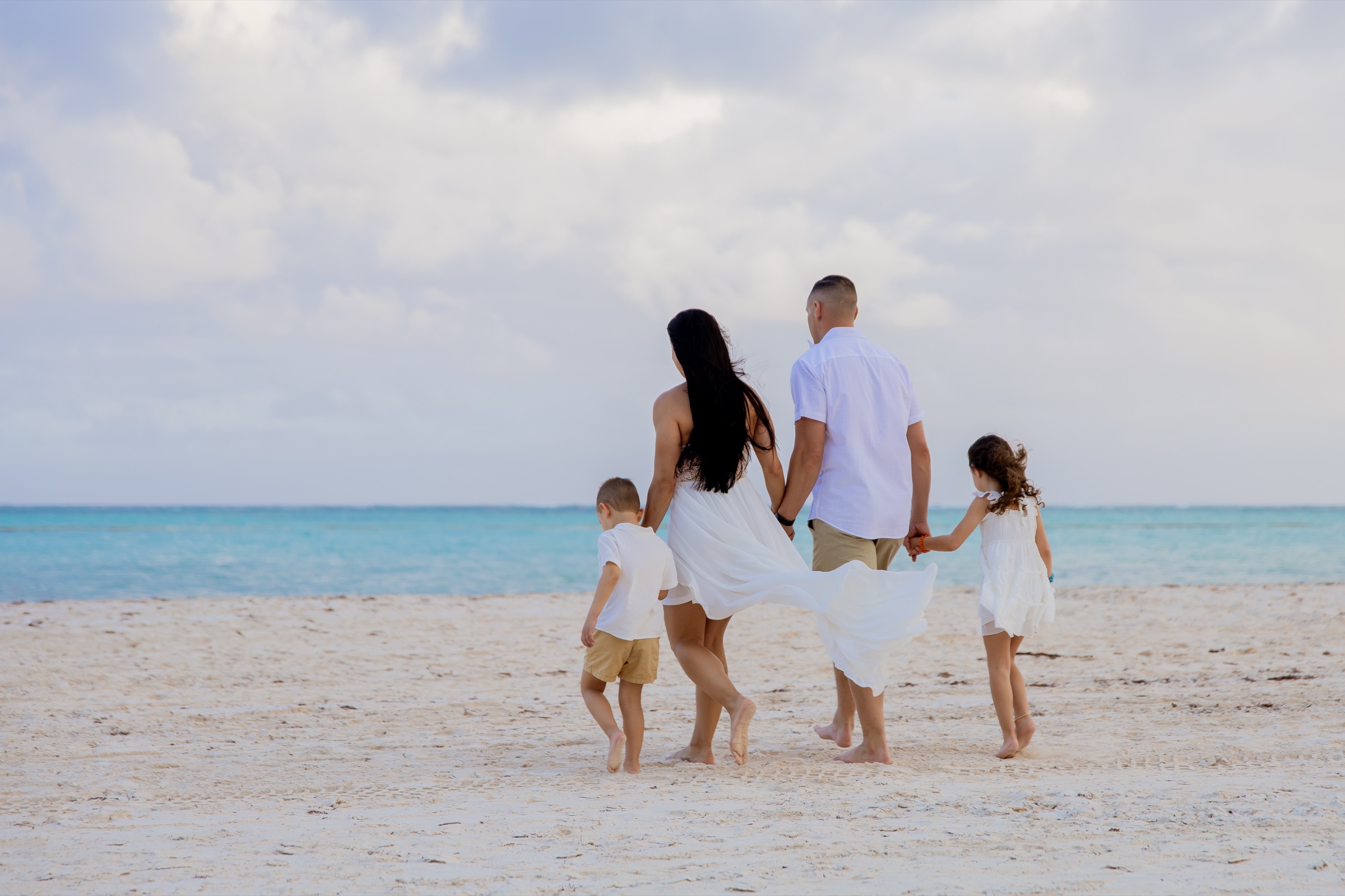 Family walking toward the ocean.